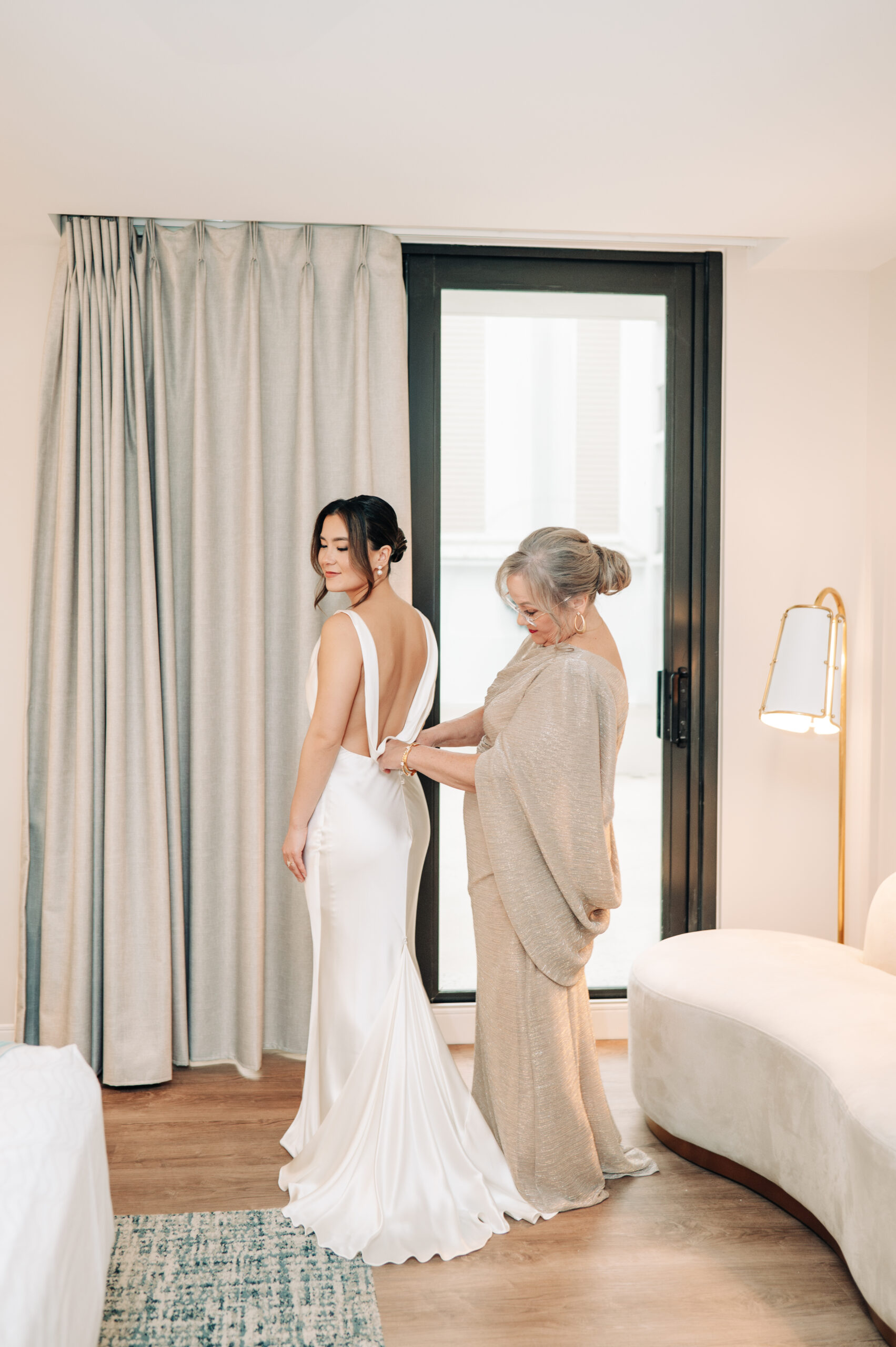 Mom helping Bride get ready for her wedding at Benvenuto